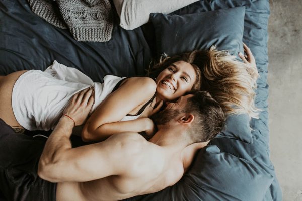Beautiful loving couple kissing in bed